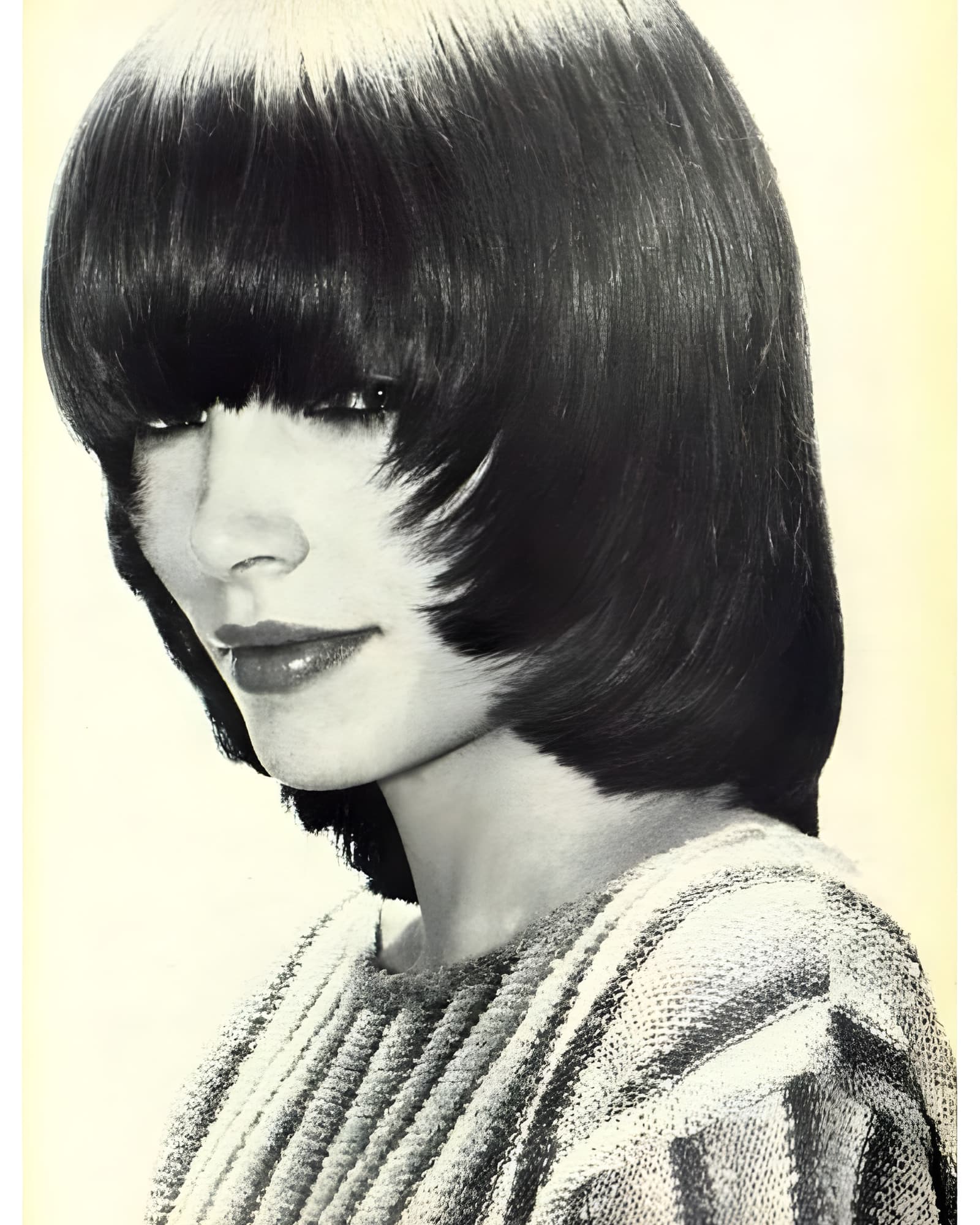 Black-and-white portrait with a sculptural dark fringe